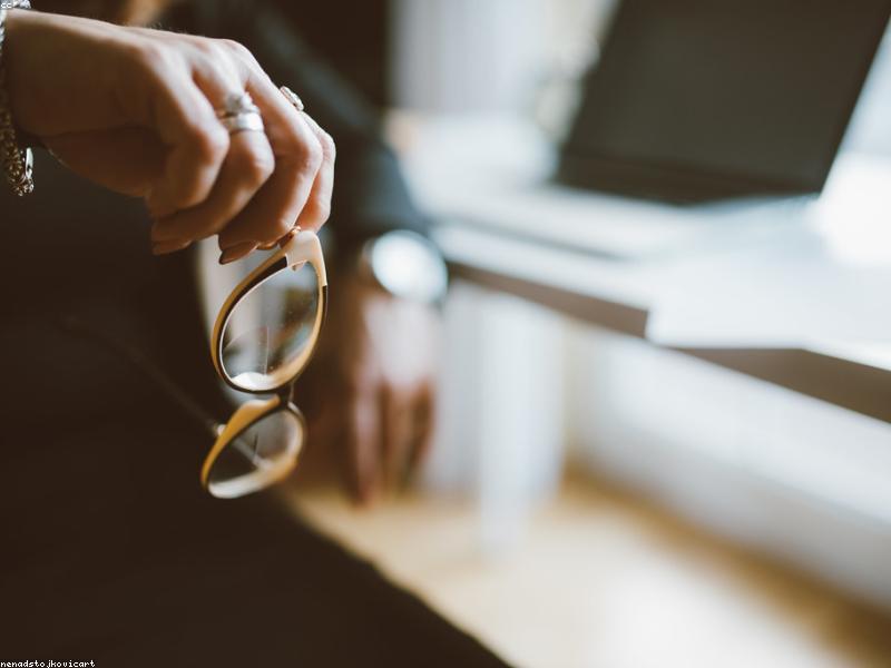 A busy desk with a calendar and a digital AI assistant on a screen