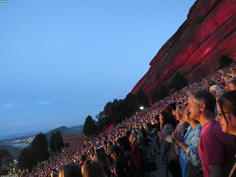 Couple sitting in the seats at Red Rocks Amphitheatre with scenic views