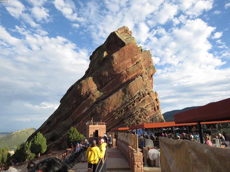 Couple sitting in the seats at Red Rocks Amphitheatre with scenic views