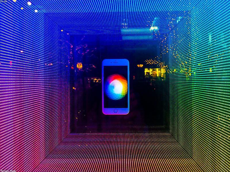 Apple Store with customers looking at iPhones