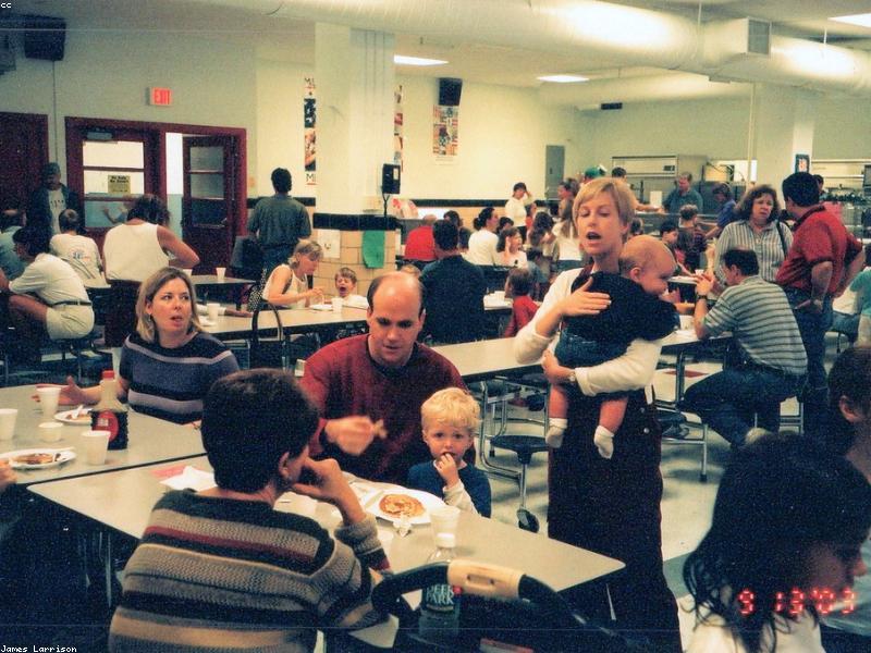 Family having dinner around a wooden table